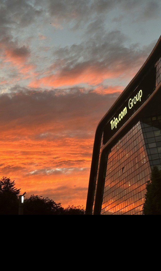 Sunset reflected on the Trip.com Group office